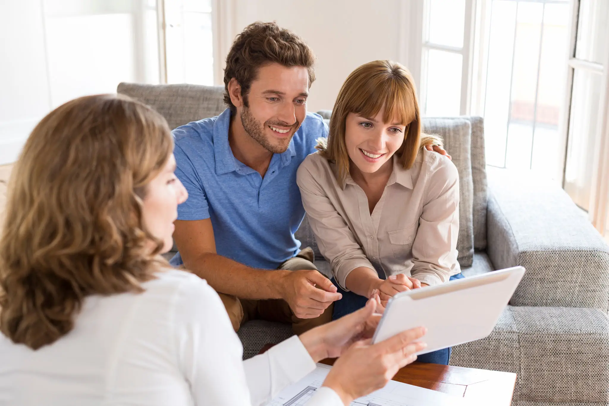 A couple discussing paperwork with a consultant.