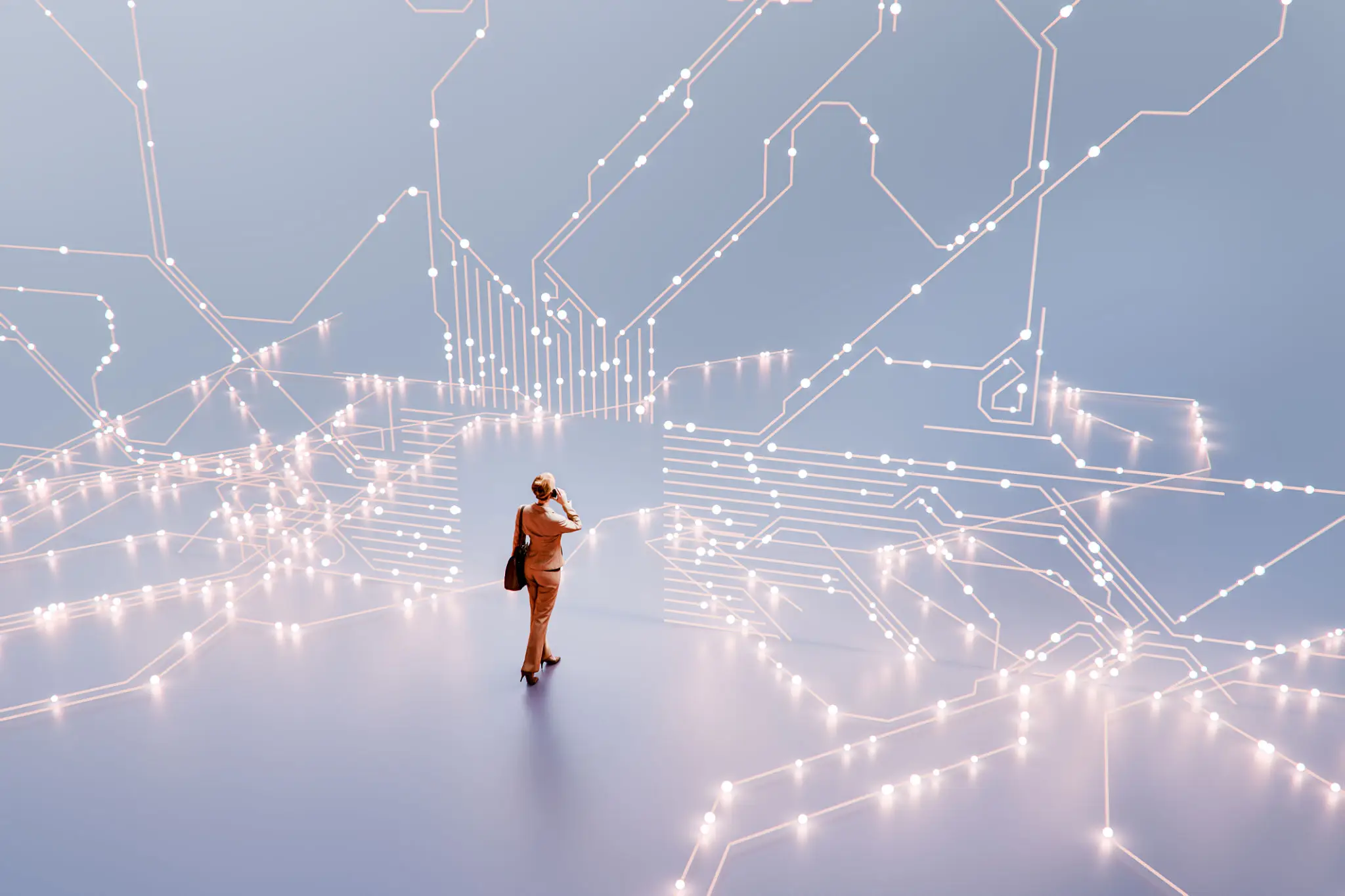 Person standing amidst glowing interconnected light nodes in a vast space.